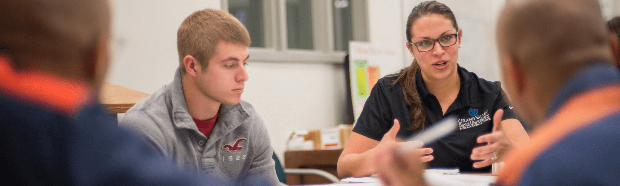 Criminal justice faculty member working with students and inmates.